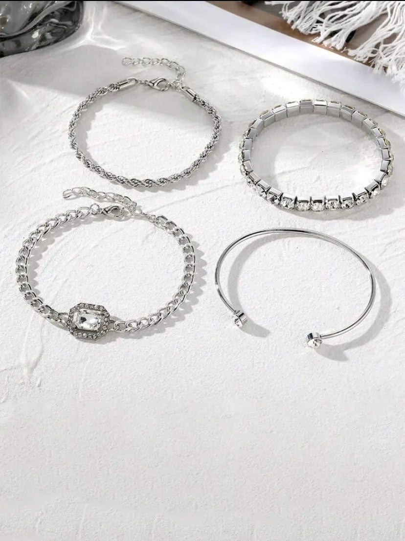 Women's four-piece alloy jewellery set with geometric square diamond shapes and chain links in gold finish