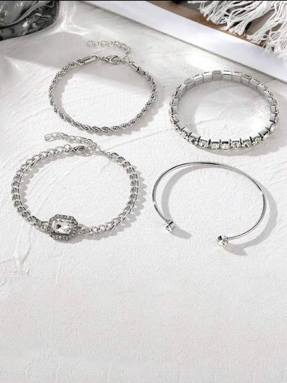 Women's four-piece alloy jewellery set with geometric square diamond shapes and chain links in gold finish