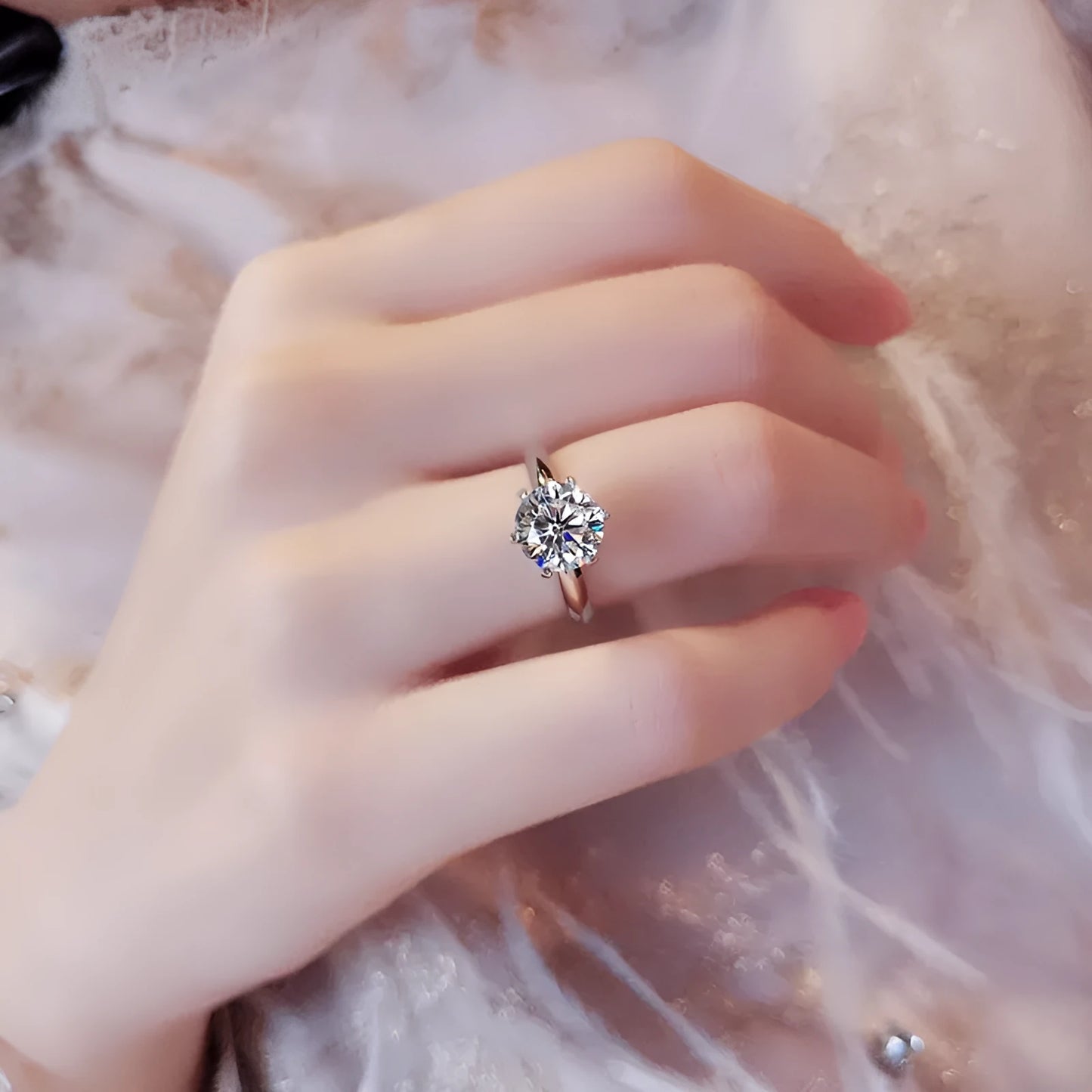 White gold plated geometric ring with a six-claw set zircon stone on a model's finger.
