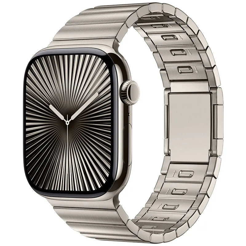 Silver stainless steel magnetic buckle strap attached to an Apple Watch on a wrist.