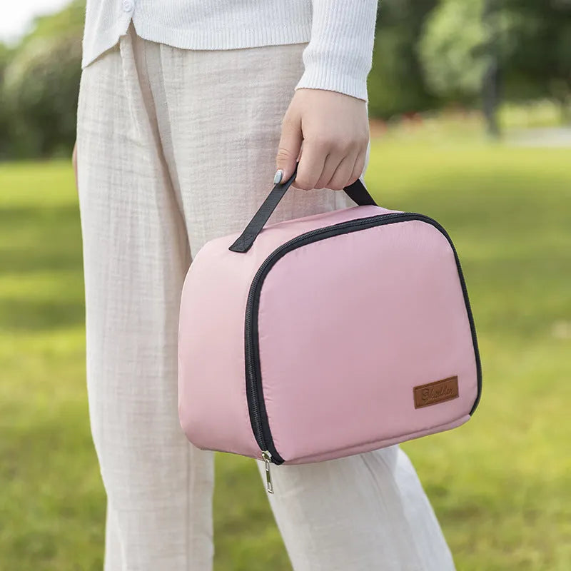 Insulated lunch box bag in sapphire blue textured cloth, shown with a lunch box inside.