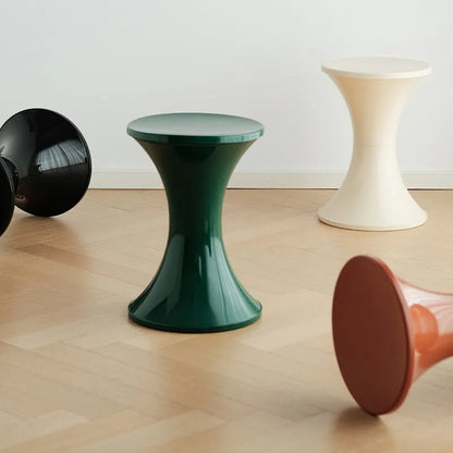 Plastic hourglass-shaped shoe changing stool in green, 40cm high and 30cm wide