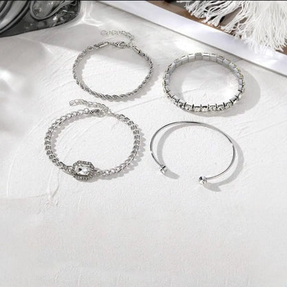 Women's four-piece alloy jewellery set with geometric square diamond shapes and chain links in gold finish
