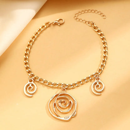 Gold spiral donut alloy jewellery set showing necklace, bracelet, and ear hooks on a plain background.