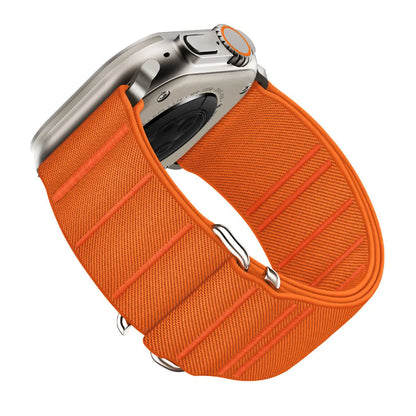 Elastic nylon Apple Watch band in Army Green with stainless steel buckle, shown on a wrist.