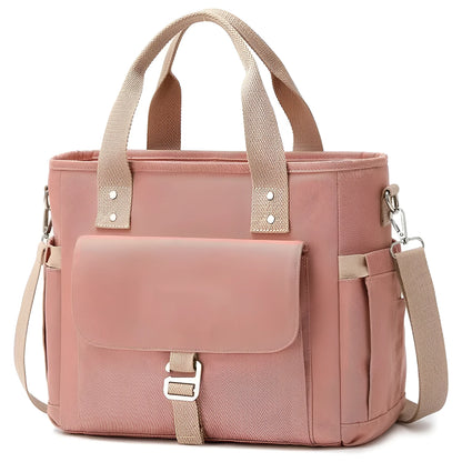 Insulated cube-shaped picnic bag with a removable shoulder strap in pink, shown with a side pocket.
