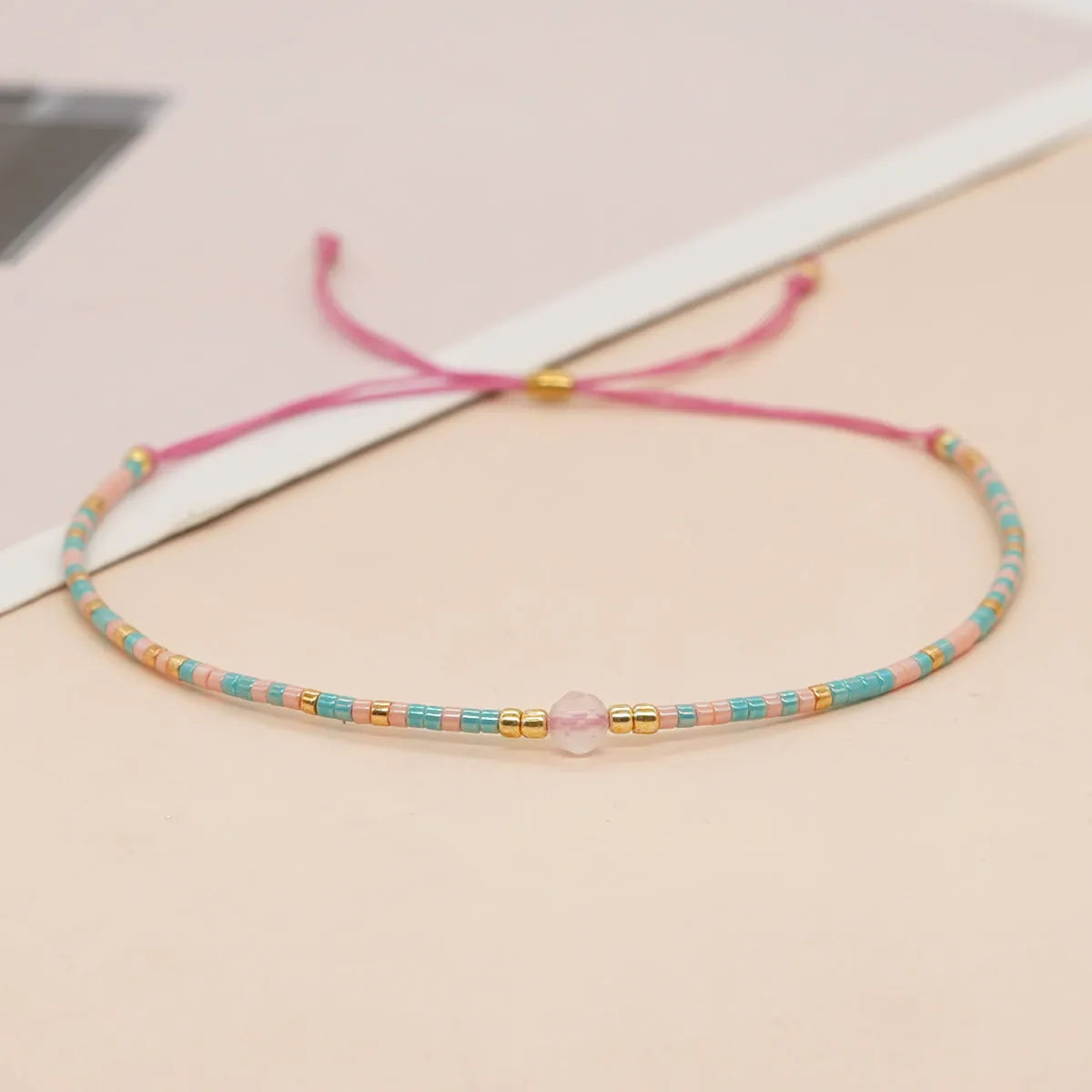 Handmade women's bracelet with colourful geometric glass and coloured glaze beads in Bohemian style.
