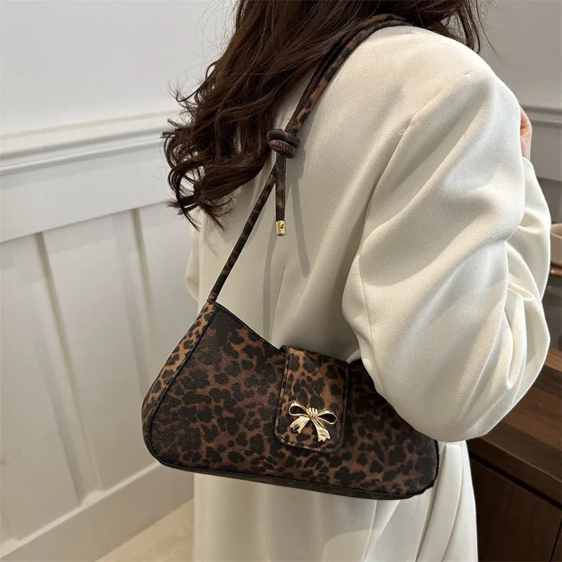 Women's casual handbag with large capacity, made from PU leather in medium-soft construction measuring 27cm width × 13.5cm height × 6cm depth, featuring outer sandwich pockets and available in black, brown, coffee, and khaki colours for everyday use