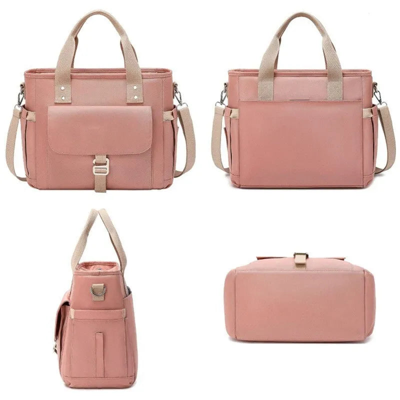 Insulated cube-shaped picnic bag with a removable shoulder strap in pink, shown with a side pocket.