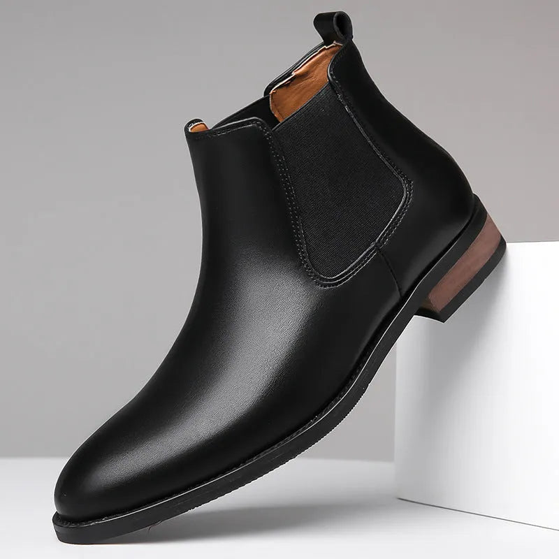 Men's black pointed toe Chelsea boots with a decorative sewing thread detail on the artificial PU upper.