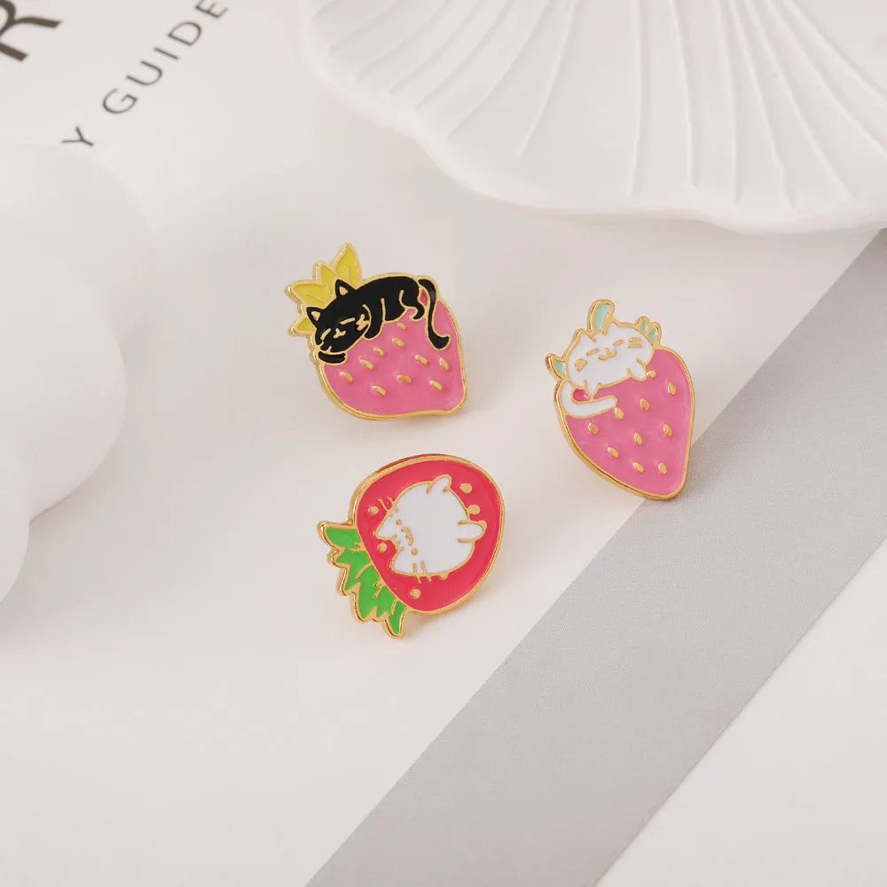 Close-up of a cute cat strawberry and dripping cake oil design metal alloy brooch pin.