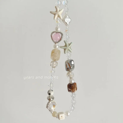 Bohemian mobile phone charm with beaded alloy design in Island Sweetheart colour on suitcase handle
