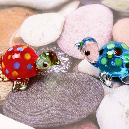 Geometric glass turtle figurine ornament on a desk, shown in blue head and blue shell colour variant.
