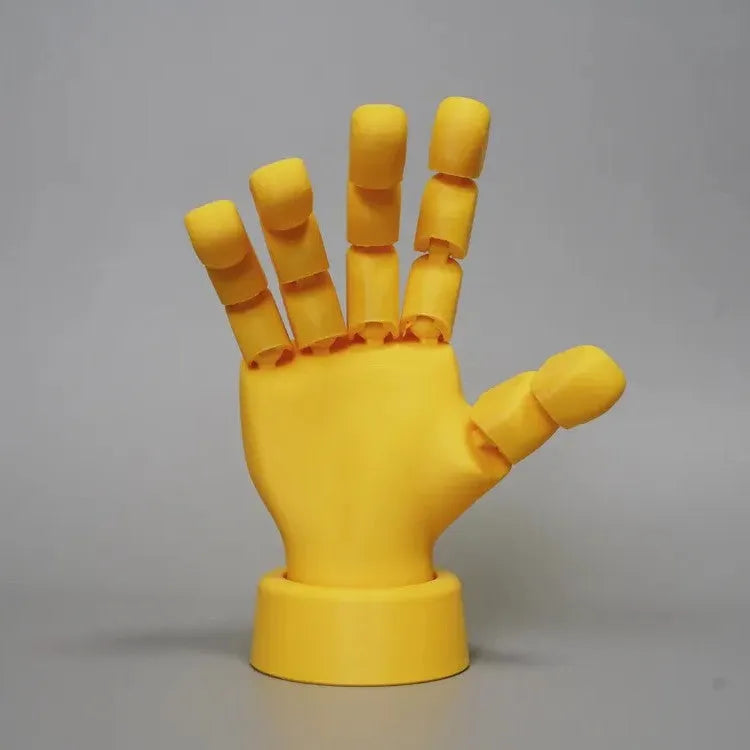 Yellow movable joint hand ornament showing articulated fingers and wrist joints