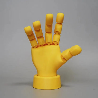 Yellow movable joint hand ornament showing articulated fingers and wrist joints
