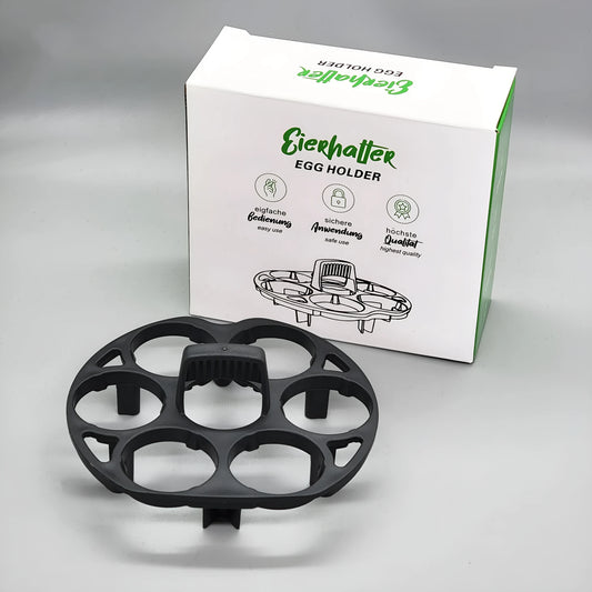 Black plastic egg holder rack for a cooking machine, shown from above.