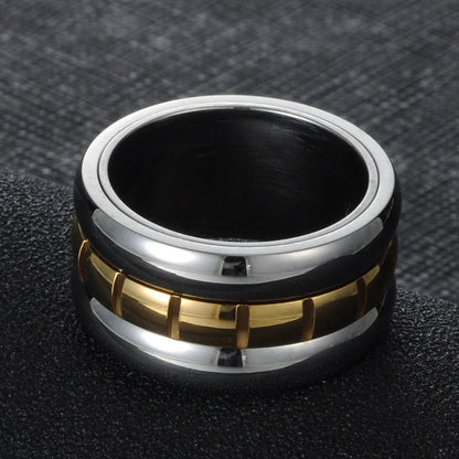 Gold ultra-wide titanium steel men's ring with a rotatable tail component on a finger.