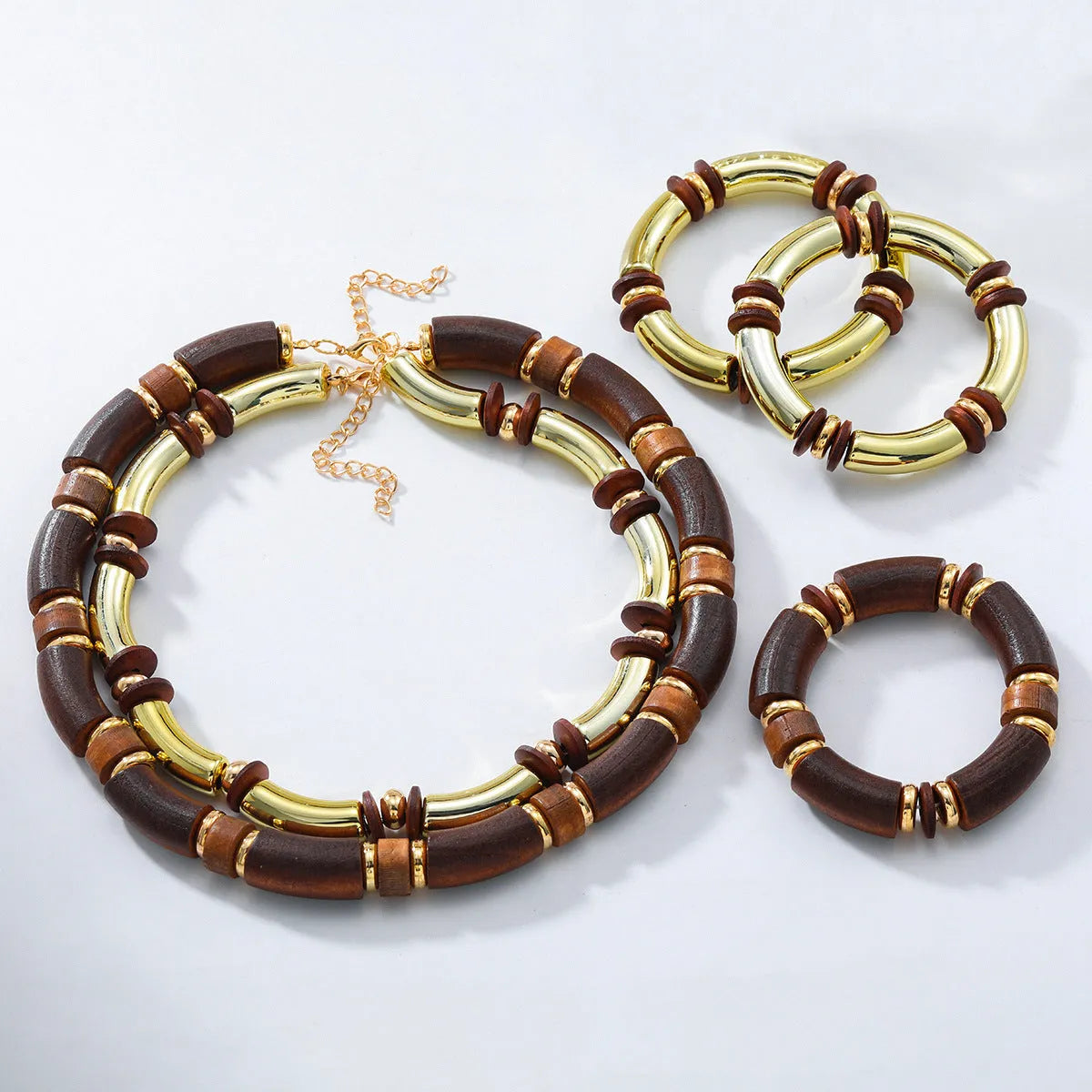 Women's exaggerated multi-layer wooden bead necklace and matching alloy bracelet set on a white background