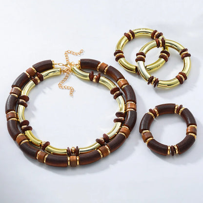 Women's exaggerated multi-layer wooden bead necklace and matching alloy bracelet set on a white background
