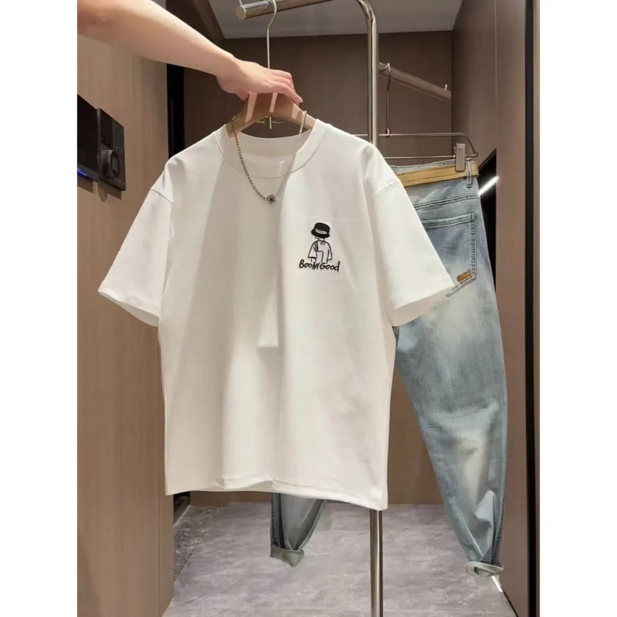 Men's black cotton t-shirt with a cartoon print, showing the slim fit and short sleeve design.