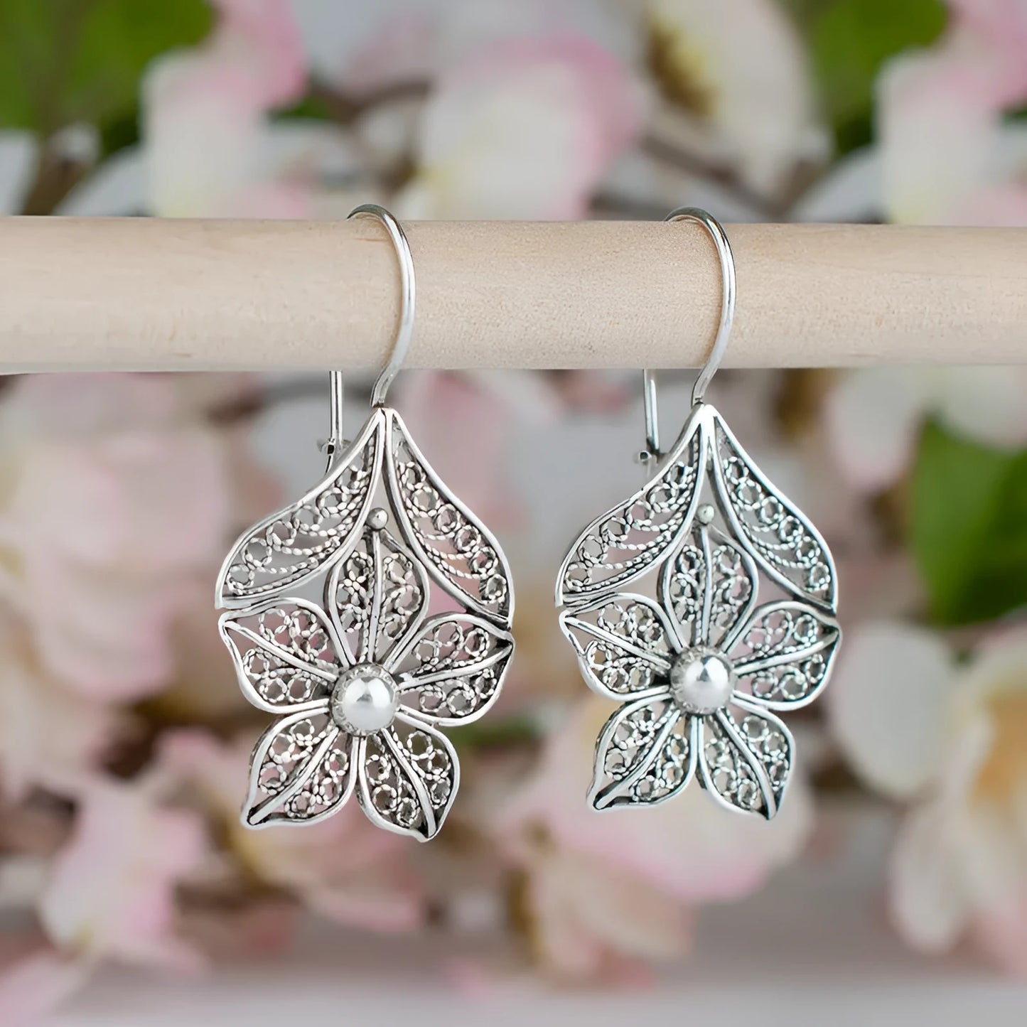 Silver hollow flower leaf-shaped alloy earrings with openwork floral detailing
