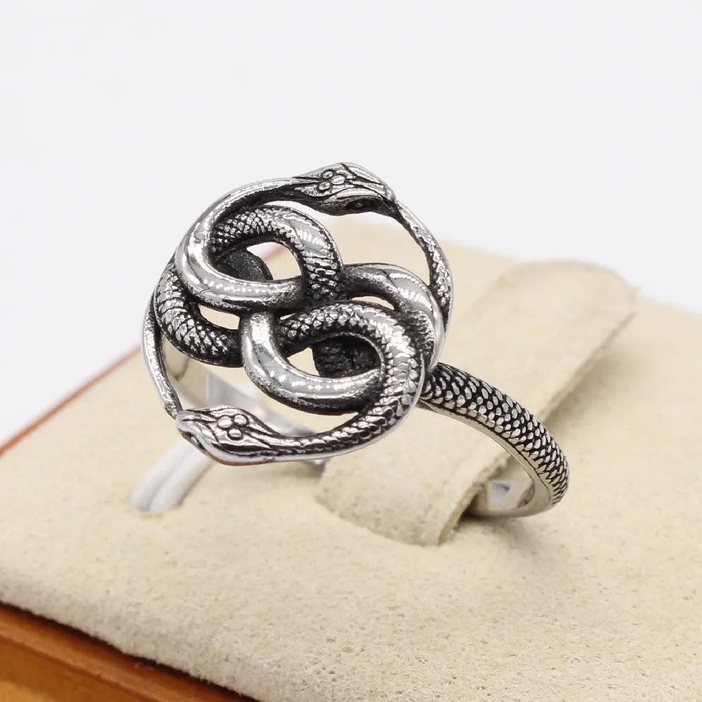 Titanium steel double snake ring in steel colour with retro design, shown on a finger.