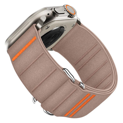Elastic nylon Apple Watch band in Army Green with stainless steel buckle, shown on a wrist.