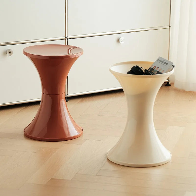 Plastic hourglass-shaped shoe changing stool in green, 40cm high and 30cm wide
