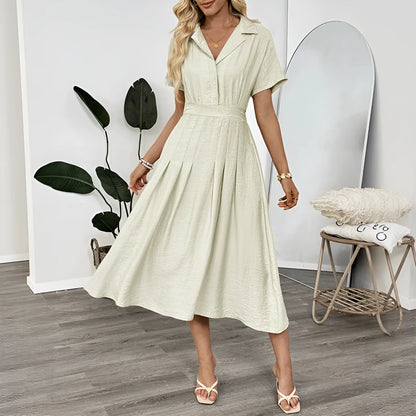 Light green women's shirt dress with lapel collar, waist tie, and pockets on a mannequin.