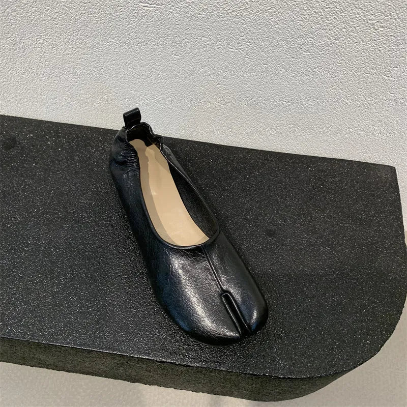 Women's black split-toe chunky heel pumps with round toe and low heel on a white background