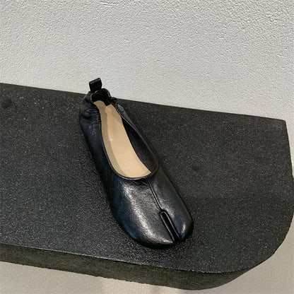 Women's black split-toe chunky heel pumps with round toe and low heel on a white background