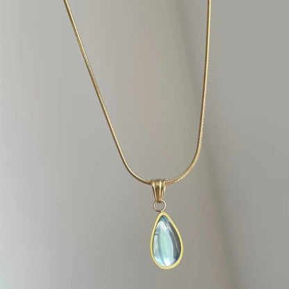 Retro style blue water drop titanium steel pendant necklace with snake bone chain on a white background.