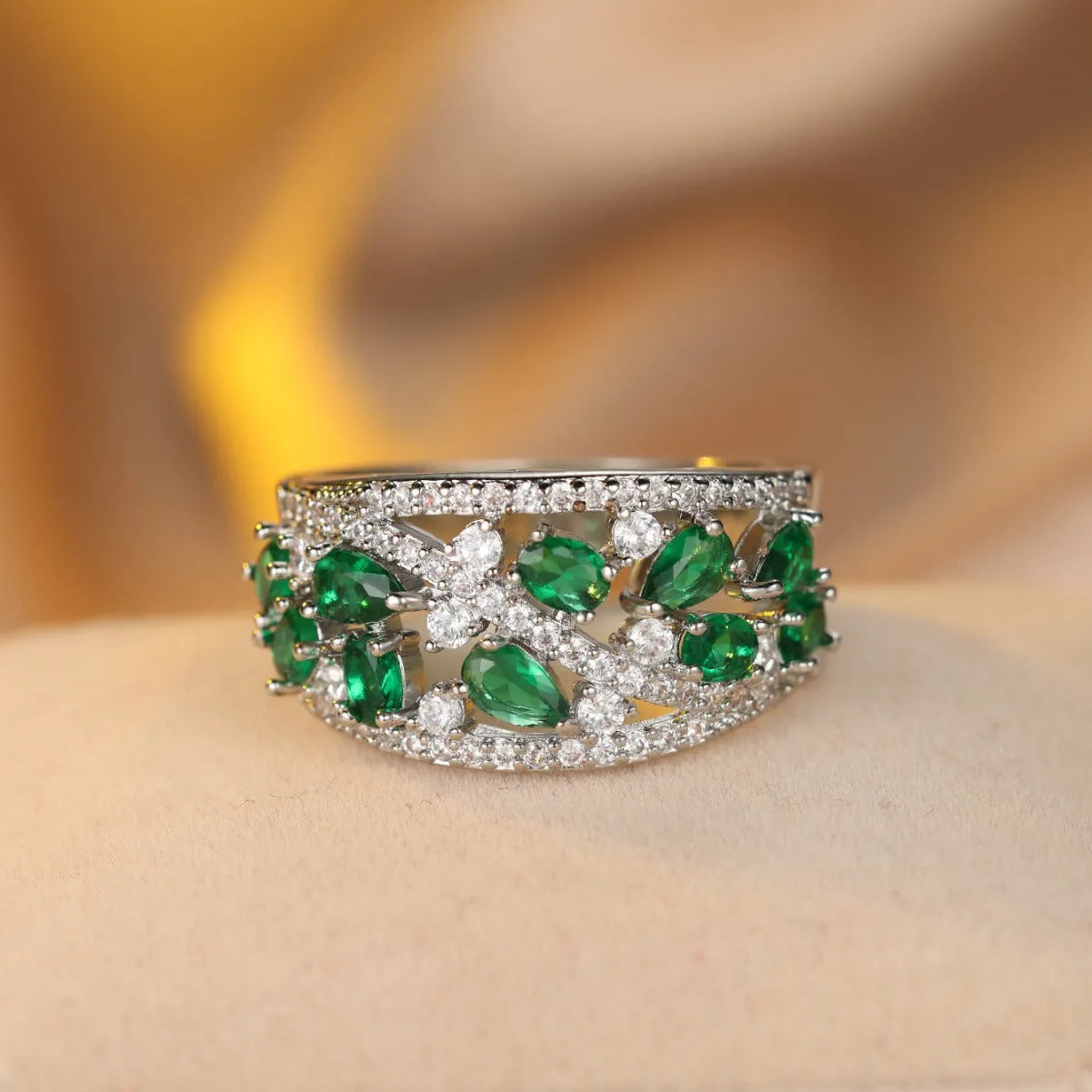 Women's round hollow copper ring showing gold and platinum plating options with sapphire blue and white accents