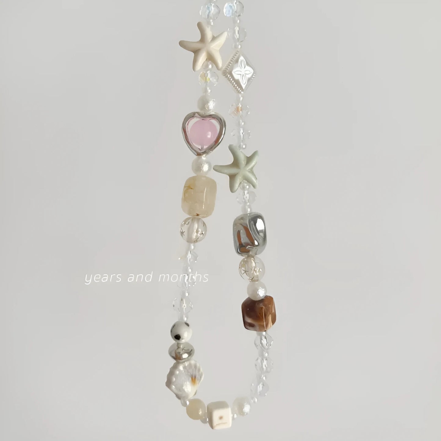 Bohemian mobile phone charm with beaded alloy design in Island Sweetheart colour on suitcase handle