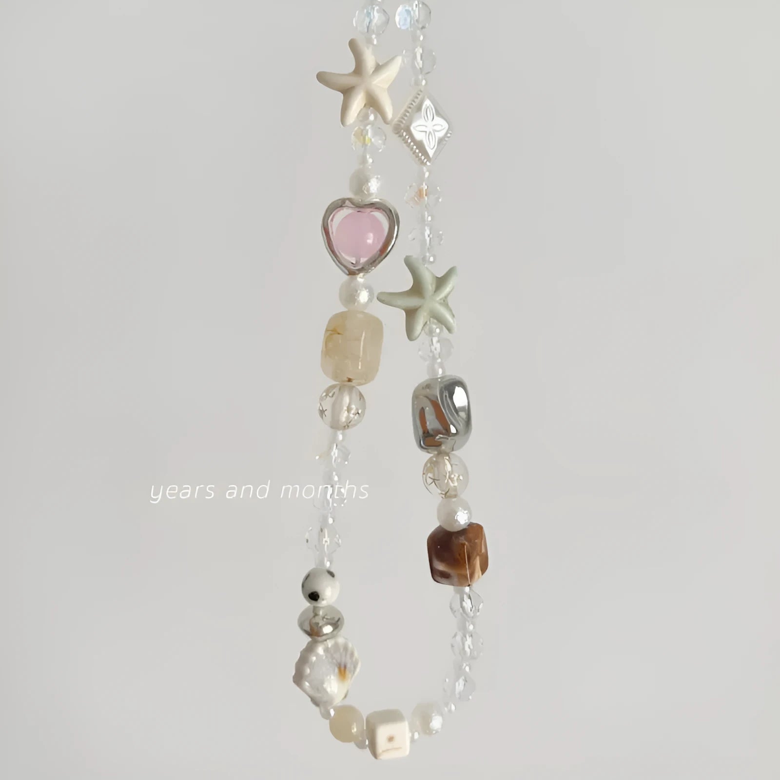 Bohemian mobile phone charm with beaded alloy design in Island Sweetheart colour on suitcase handle