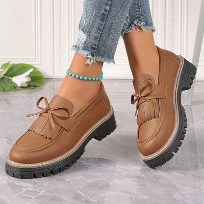 Women's black plus size loafers with tassel, bowknot, chunky heel, and rubber sole