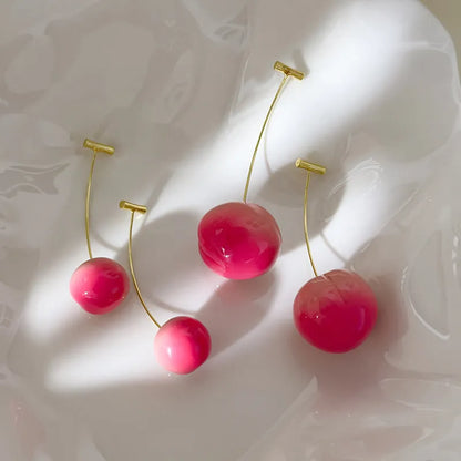 Acrylic peach-shaped earrings with copper posts in small and large size options