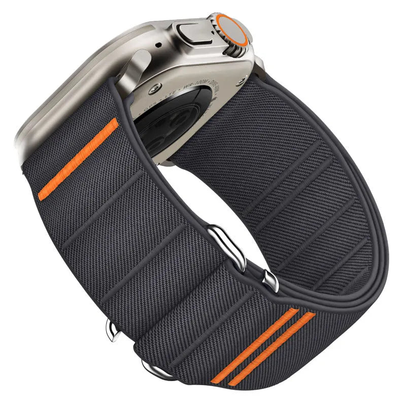 Elastic nylon Apple Watch band in Army Green with stainless steel buckle, shown on a wrist.