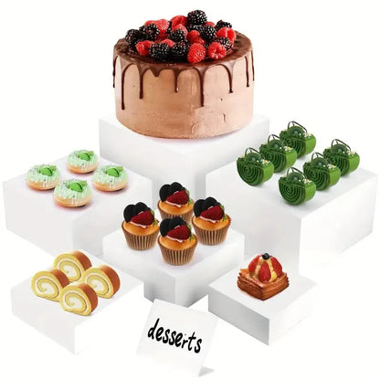 Six acrylic cubes in graduated sizes 3-8cm for dessert display, available in transparent or white