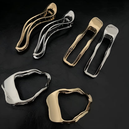 Women's gold and silver zinc alloy hair barrettes in arc, square, and triangle shapes.
