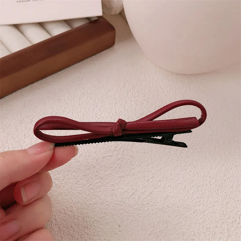 Wine red leather bow hair barrette with 2.5cm bow width and 5cm clip length