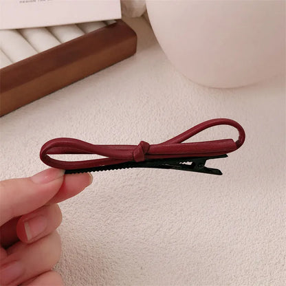 Wine red leather bow hair barrette with 2.5cm bow width and 5cm clip length