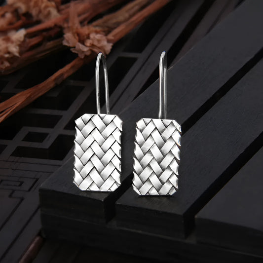 A pair of 925 sterling silver earrings with a woven geometric plaid pattern, showing front detail.