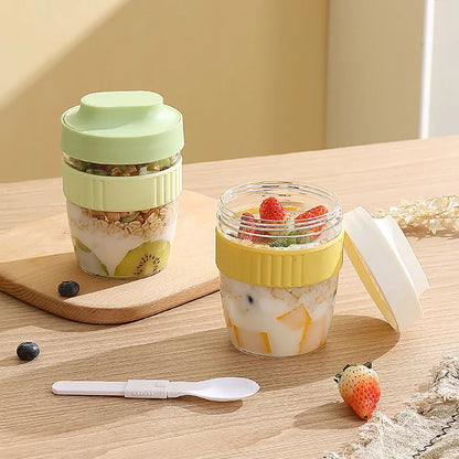 Green PP plastic salad cup with attached lid and spoon on a white background.