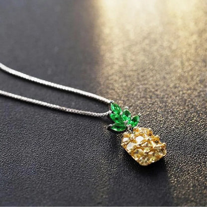 Geometric pineapple pendant necklace with silver and copper white gold plated finish on model