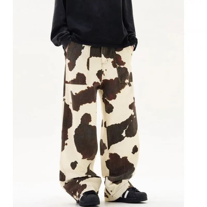 Men's straight-leg trousers with a brown and white cow pattern print.