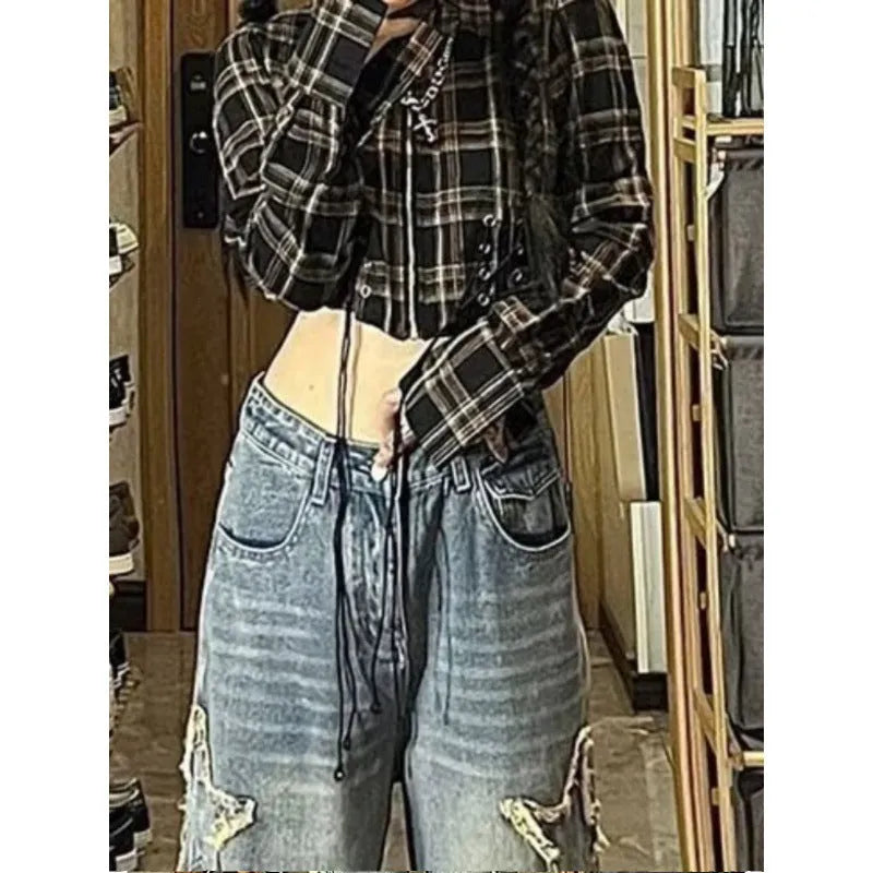 Blue high-waisted straight-leg women's jeans on a hanger, showing the waistband and leg cut.