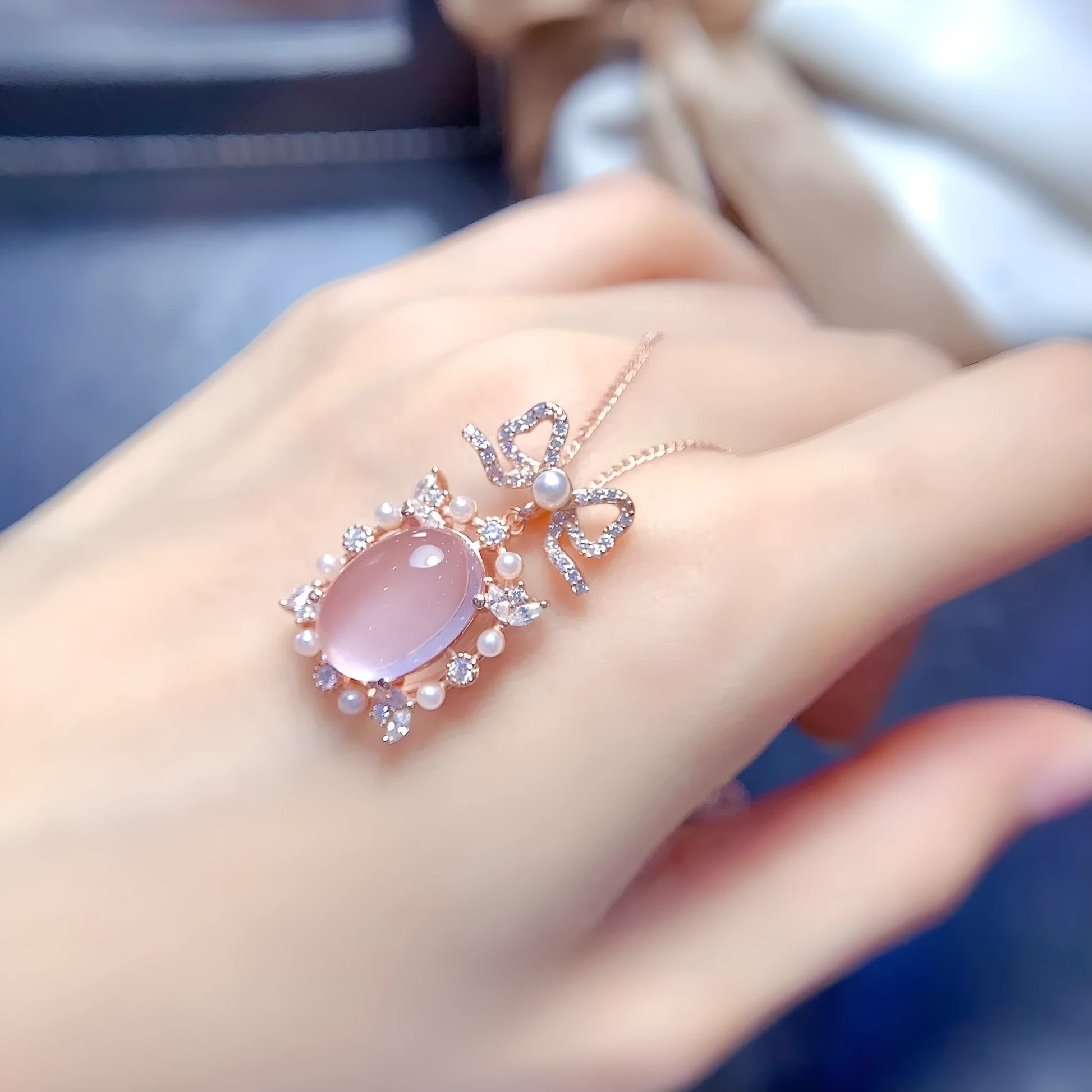 Geometric rose quartz pendant necklace on sterling silver chain with rose gold plating.