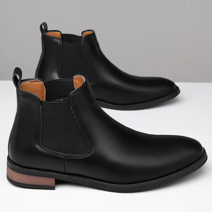 Men's black pointed toe Chelsea boots with a decorative sewing thread detail on the artificial PU upper.