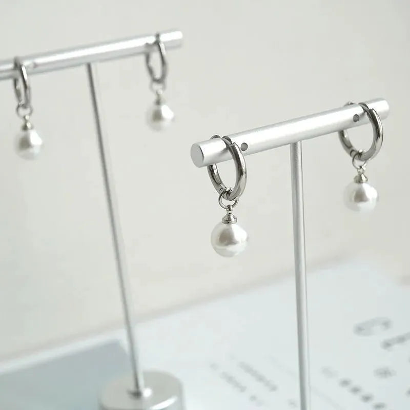 Geometric round pearl drop earrings for women with alloy metal and titanium steel posts.